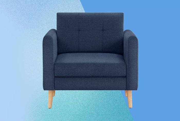 A deep blue Burrow Armchair set against a blue backdrop