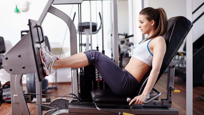 individual using a leg press machine