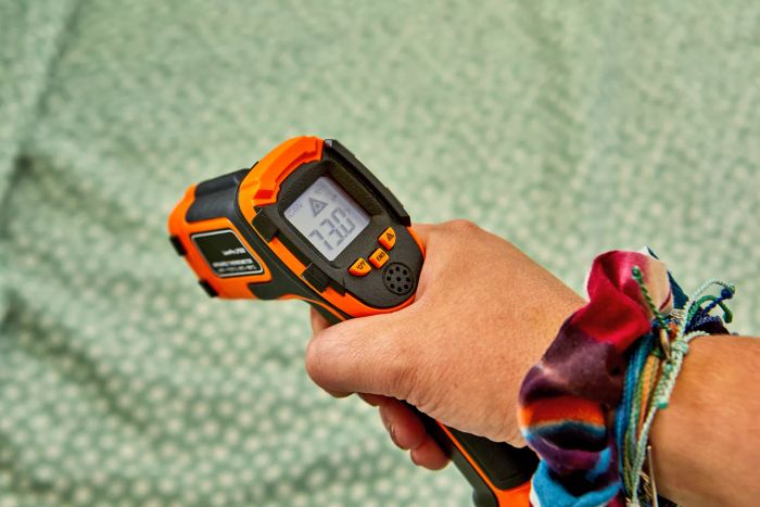 A hand testing the warmth of the True North by Sleep Philosophy Flannel Sheet Set