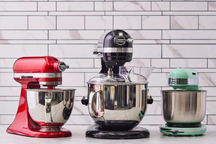 The KitchenAid Artisan Mini and Pro Line Series 7-Quart Bowl-Lift Stand Mixers are shown alongside another stand mixer model against a neutral, light-colored tile backdrop.