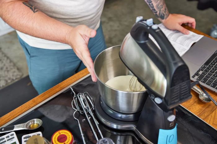 A person testing one of the stand mixers we recommend.