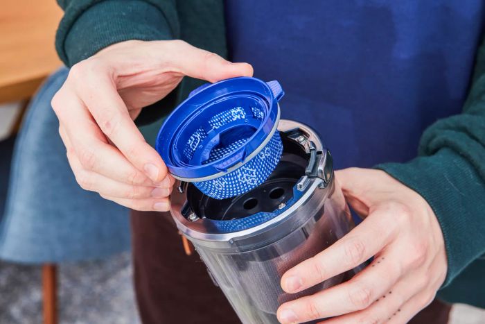 A person taking out the filter from the Samsung Jet 90 Vacuum