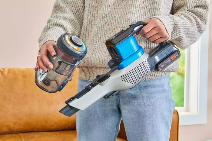 A person holding components of the BLACK+DECKER Powerseries Extreme Cordless Stick Vacuum Cleaner