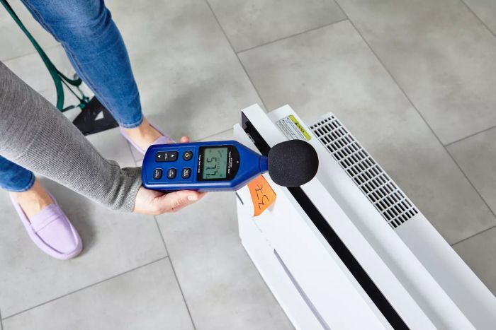 A hand measuring decibel levels above the Rabbit Air MinusA2 Ultra Quiet HEPA Air Purifier SPA-780A