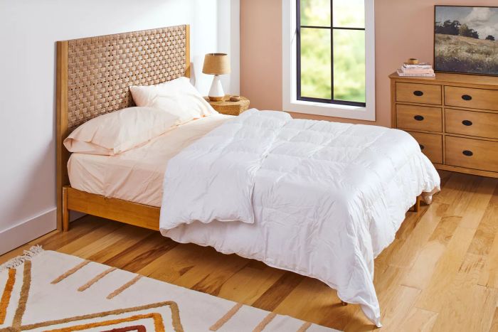A bed with pillows and the Kassatex European White Goose Down Comforter neatly arranged.