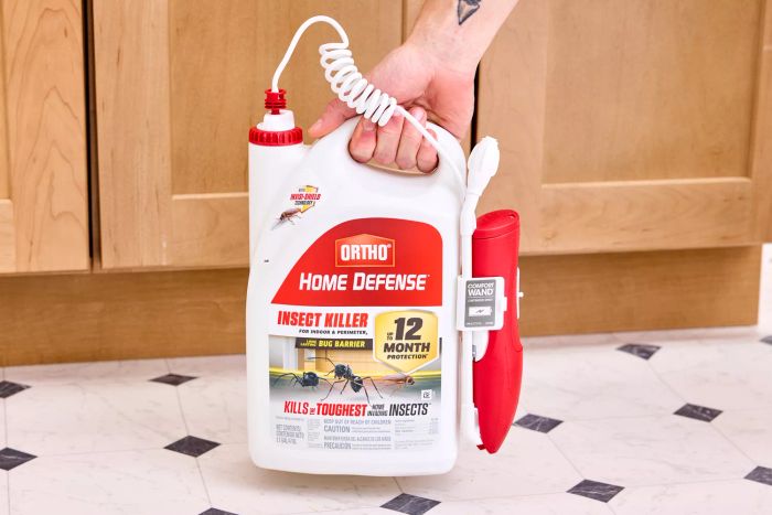 A hand grasping the Ortho Home Defense Insect Killer by its handle