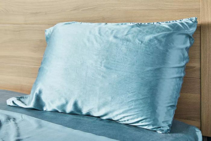 Colorado Home Co. Mulberry Silk Bed Sheets Set showcased on a bed with a wooden headboard