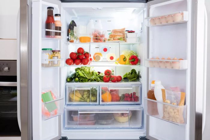 Refrigerator stocked with fresh produce and groceries