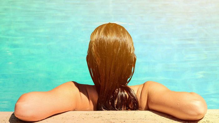 To protect your hair from chlorine and saltwater, wearing a swim cap is an essential step. It helps to shield your hair from exposure to damaging elements in the water.