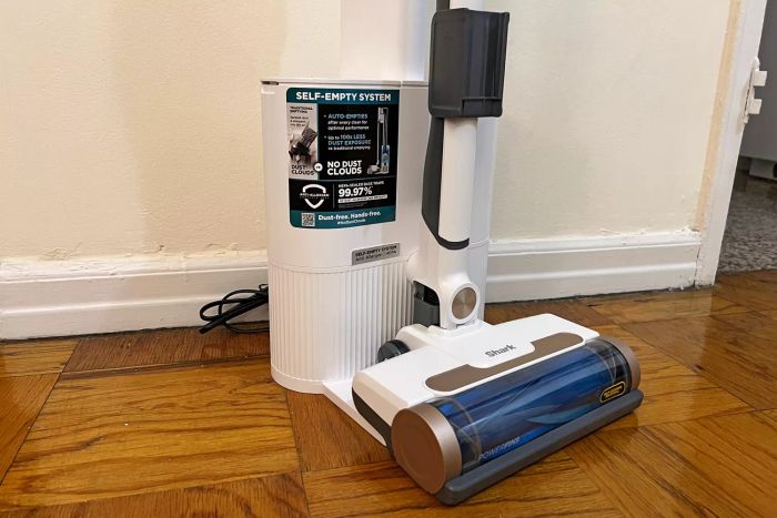 Shark WS642AE Wandvac Cordless Stick Vacuum with Self-Empty Charging Base placed on a wooden floor
