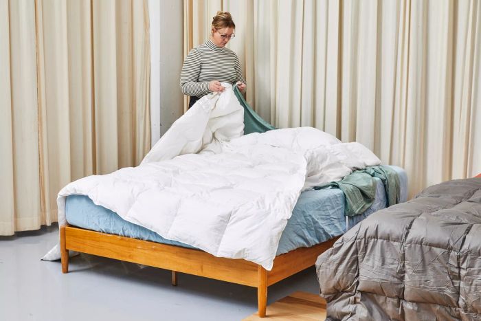 A person holding the Casaluna Premium Down Comforter in their hands.