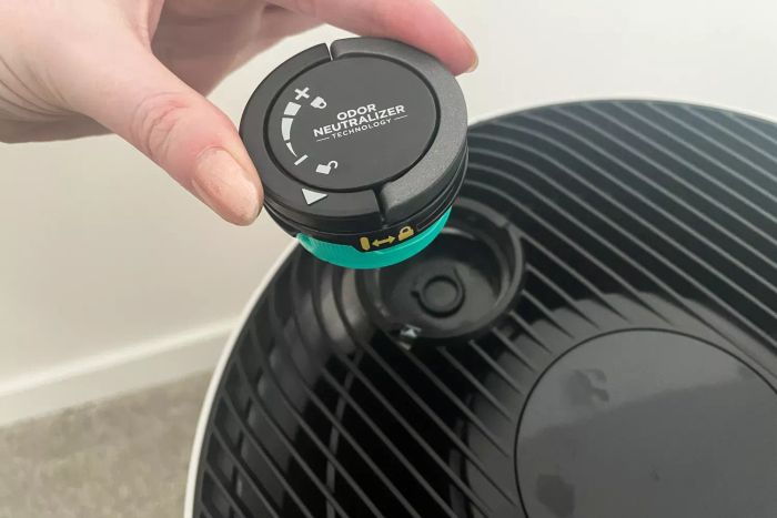 A person attaching the odor neutralizer to the Shark NeverChange Air Purifier MAX