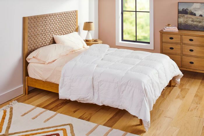 A neatly made bed featuring the Casaluna Premium Down Comforter.