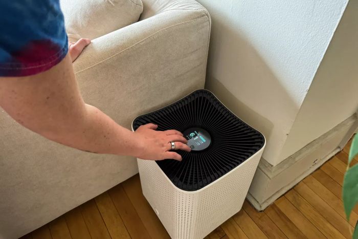 A person activating the Mila Air Purifier with Basic Breather Filter