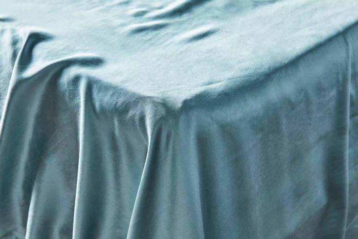 Colorado Home Co. Mulberry Silk Bed Sheets Set elegantly draped over the corner of a bed