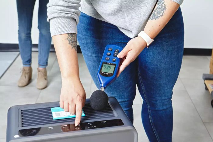 A person measuring the sound levels of the Bissell air400 Professional Air Purifier