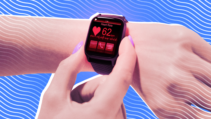 A detailed view of a smartwatch on a wrist showing heart rate metrics