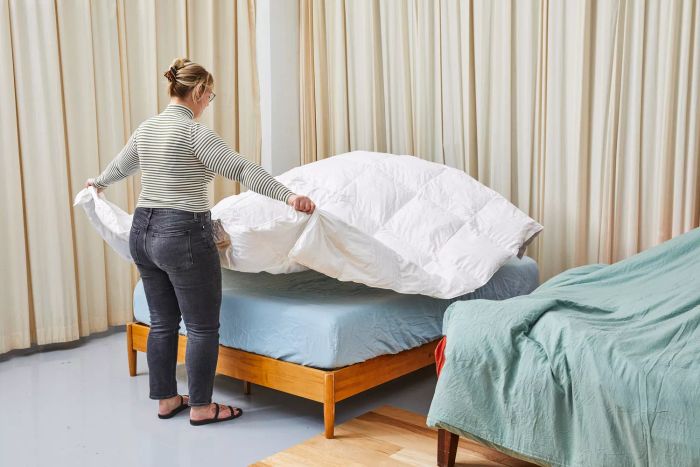 A person raising the Casaluna Premium Down Comforter.