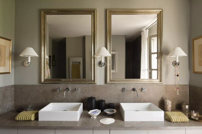 A modern bathroom featuring dual square sinks and mirrors, styled in elegant grey tones