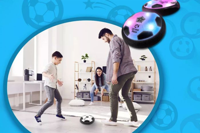 People are having fun playing with the Let Loose Moose Hover Soccer Ball indoors at home.