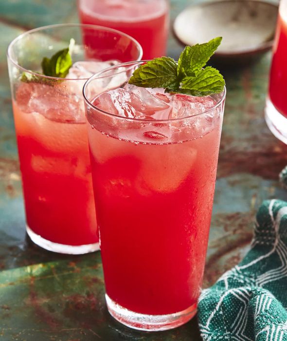 Watermelon-Mint Agua Fresca Served in Three Transparent Glasses with Mint Garnish