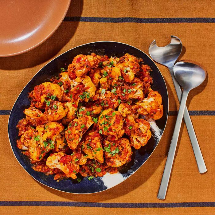 Punjabi Cauliflower Side Dish on a Serving Platter With Metal Serving Spoons