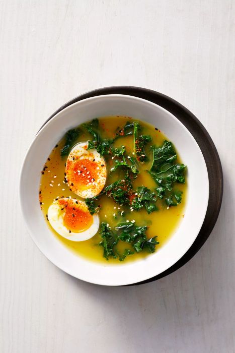 Ginger-Miso Broth with Wilted Greens in a White Bowl, Topped with a Boiled Egg