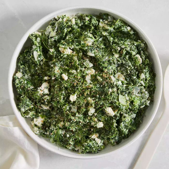 Spanakopita Creamed Spinach in a white bowl: A rich, comforting side dish featuring creamy spinach, inspired by the flavors of spanakopita, perfect for any festive meal.