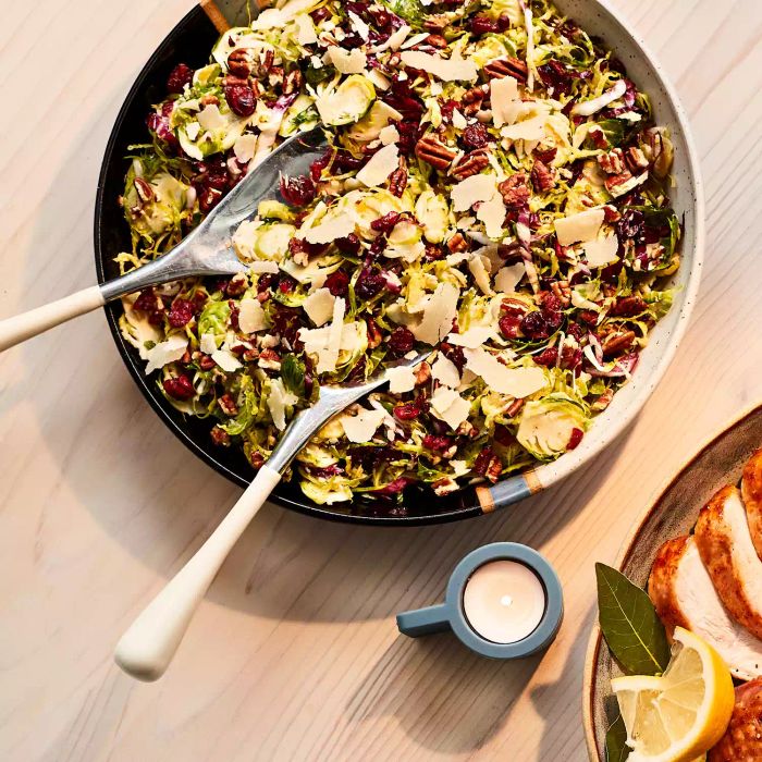 Brussels Sprouts Salad: A fresh, crunchy salad combining Brussels sprouts, radicchio, pecans, and dried cranberries, dressed in a tangy vinaigrette and topped with freshly shaved Parmesan cheese.