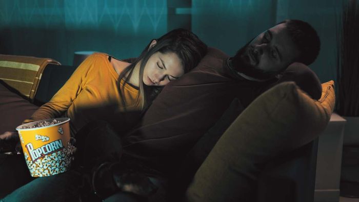 a couple resting on a couch