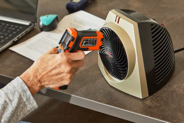 Person's hands checking temperature of Vornado VH203 75 Square Foot Personal Space Heater with Vortex Circulation