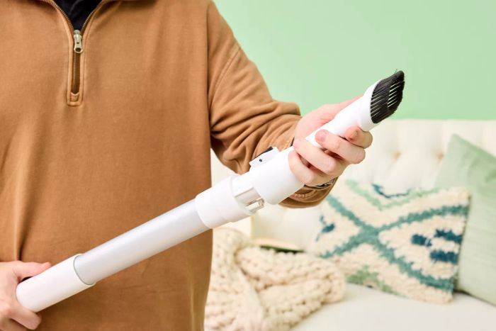 A person holding the Tineco Pure One S15 Pro Vacuum in their hands, ready for use.