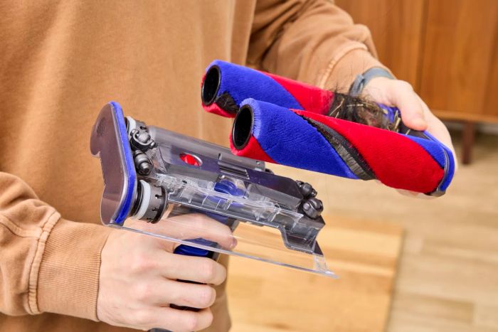 A person is holding the base pads of the Dyson Omni-Glide Cordless Vacuum.