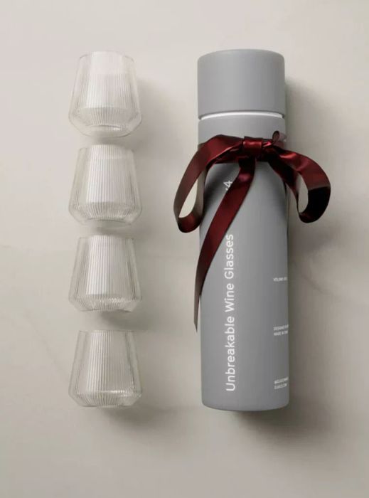 A set of four durable glasses and a container, designed to endure daily use while adding a touch of style to your beverages.
