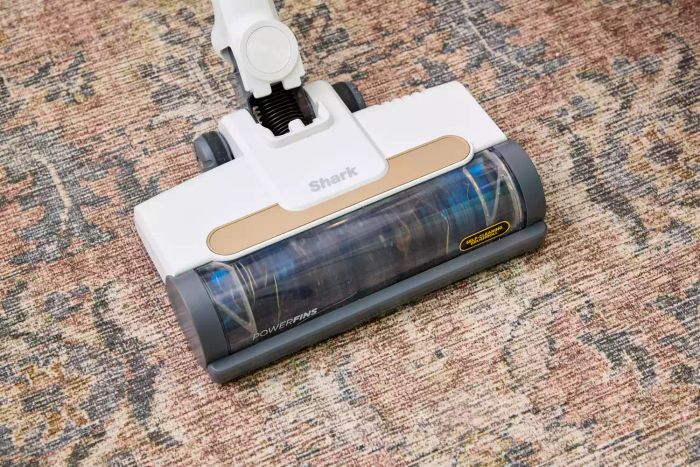 The Shark WS642AE Wandvac Cordless Stick Vacuum resting on a rug.