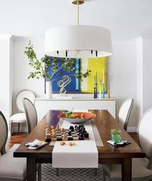 Feng Shui dining room with wooden table and white chairs