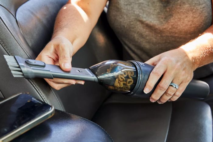 Hands attaching tool to the Bissell AeroSlim Cordless Handheld Vacuum