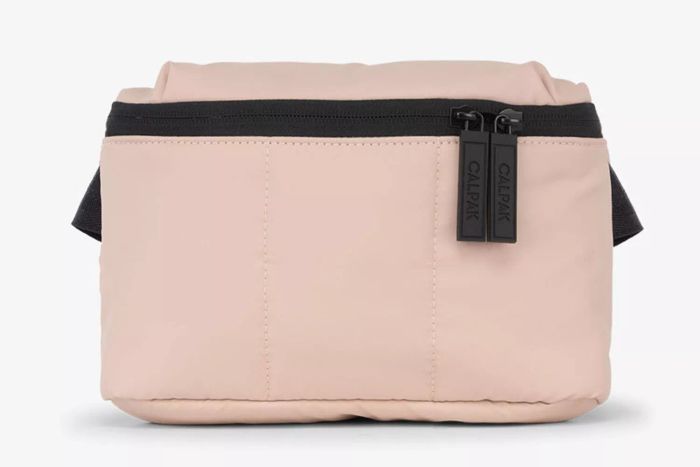 The Luka Mini Belt Bag in a lovely Rose Quartz color brings both practicality and elegance to your look.