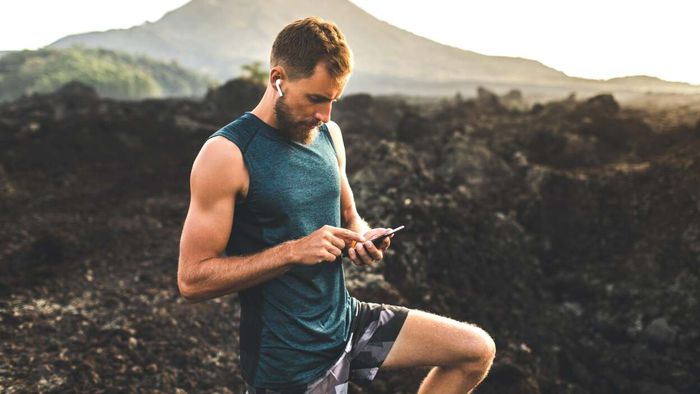 individual using their phone in the woods