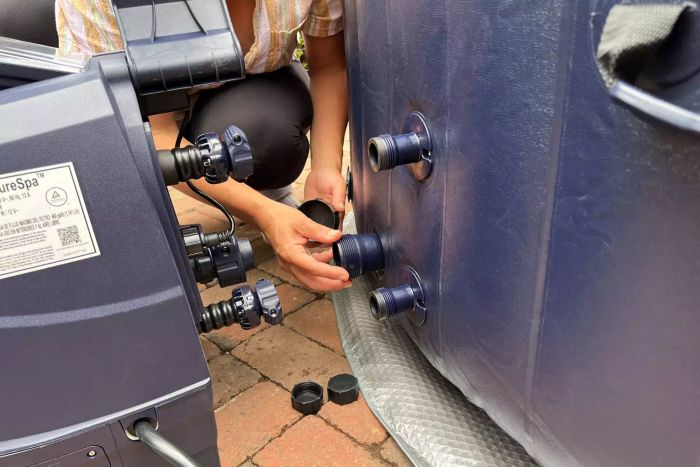 Person assembles parts of the Intex PureSpa Plus 6-Person Portable Inflatable Hot Tub