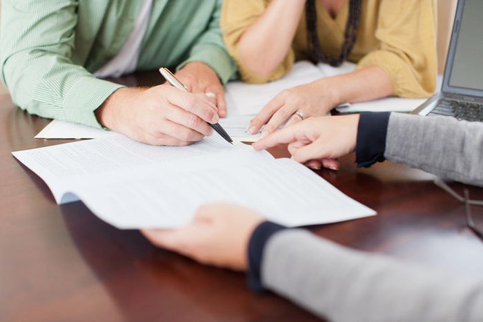A couple signing a contract