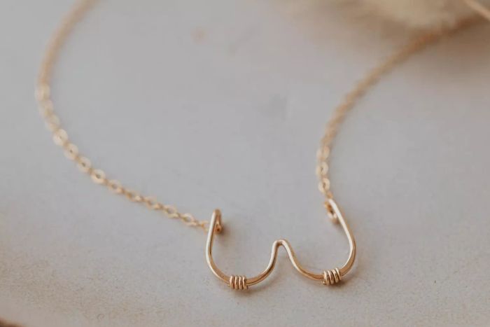 This stunning Dolly Parton-inspired necklace, crafted from 14K gold fill and sterling silver, champions body positivity and aids those fighting breast cancer. For the whole year, 50% of the profits from this piece will go to support families battling breast cancer. Every month, Hello Adorn selects three jewelry pieces, with all proceeds going toward causes such as social justice, body positivity, and racial justice.