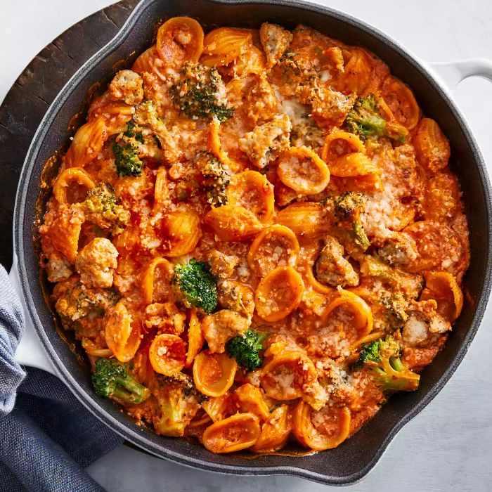 A serving of cheesy baked pasta in a dutch oven.