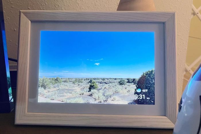 The Aeezo WiFi Digital Picture Frame displayed in landscape orientation, showing a scenic outdoor photograph.