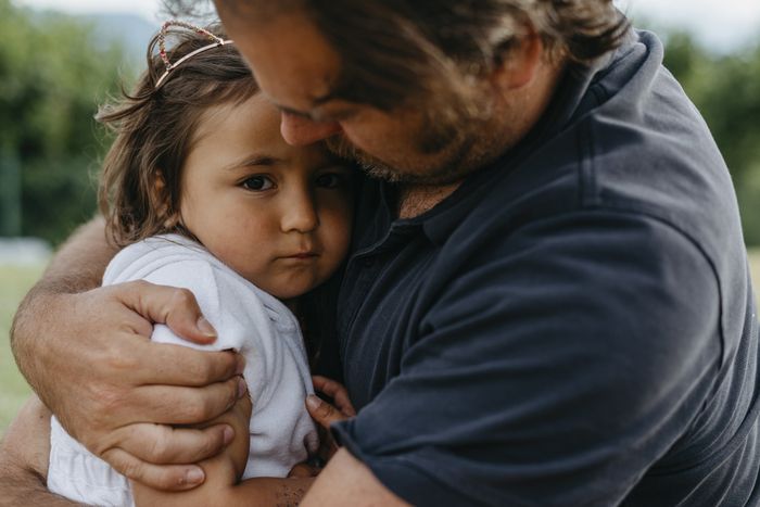A man embracing a young girl