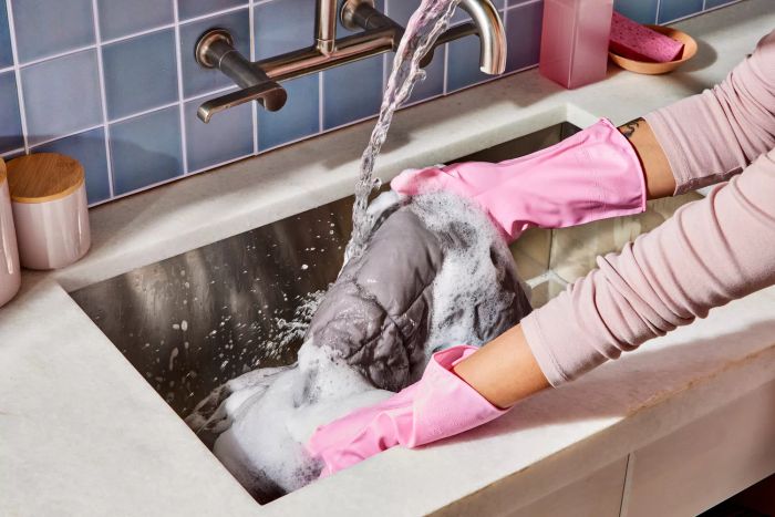 A woman cleaning a duvet