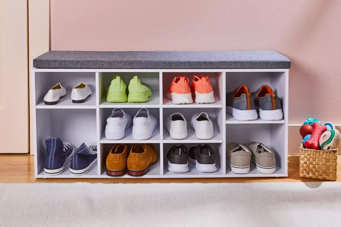 The VASAGLE Shoe Bench showcased on a wooden floor with various types of footwear