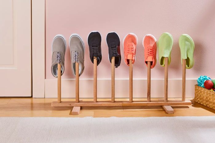 The Container Store 4-Pair Natural Boot Rack showcased on a wooden floor with shoes neatly arranged
