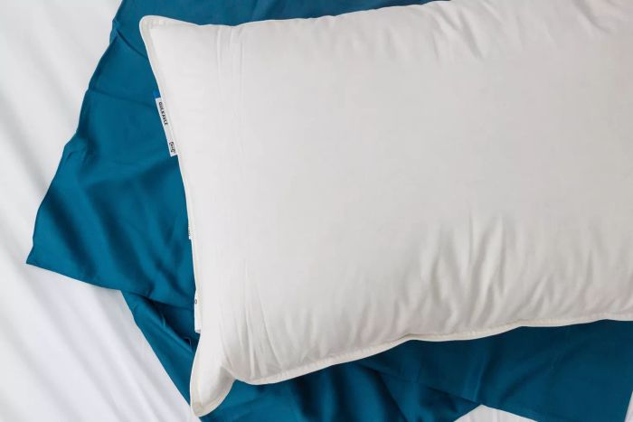 The IKEA Gulkavle Pillow placed atop a pillowcase