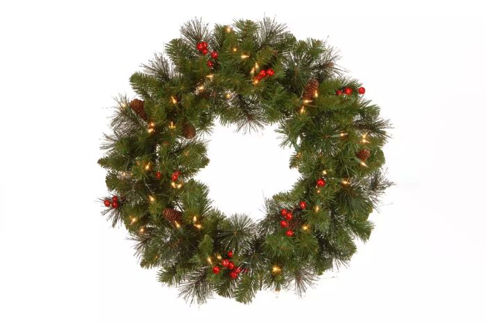 The Holiday Aisle Crestwood Spruce Wreath with Clear Lights features a stunning blend of lush evergreen foliage and clear lights, perfect for adding a touch of seasonal cheer to your décor.